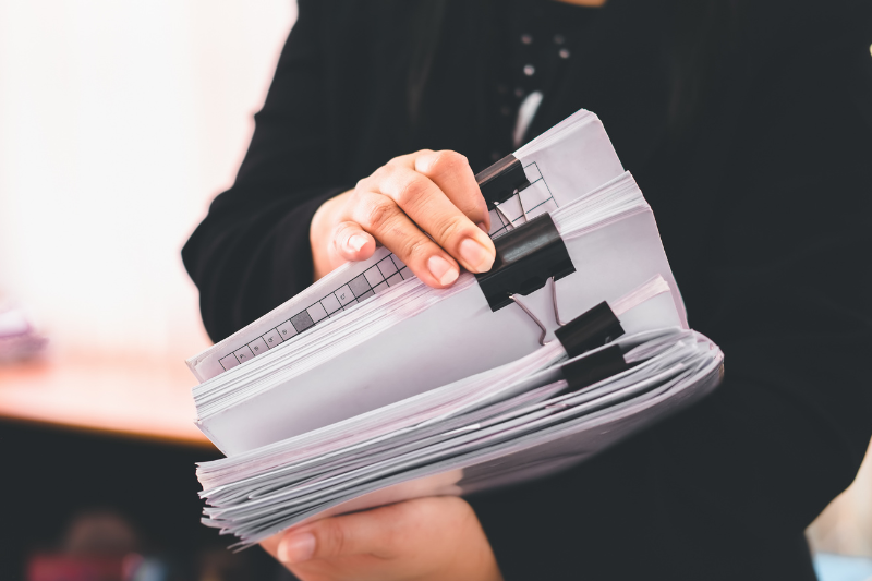 Frau mit Unterlagen in den Armen