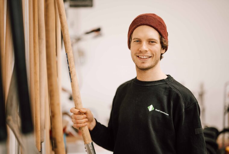 Ein junger Mann greift nach einem Werkzeug